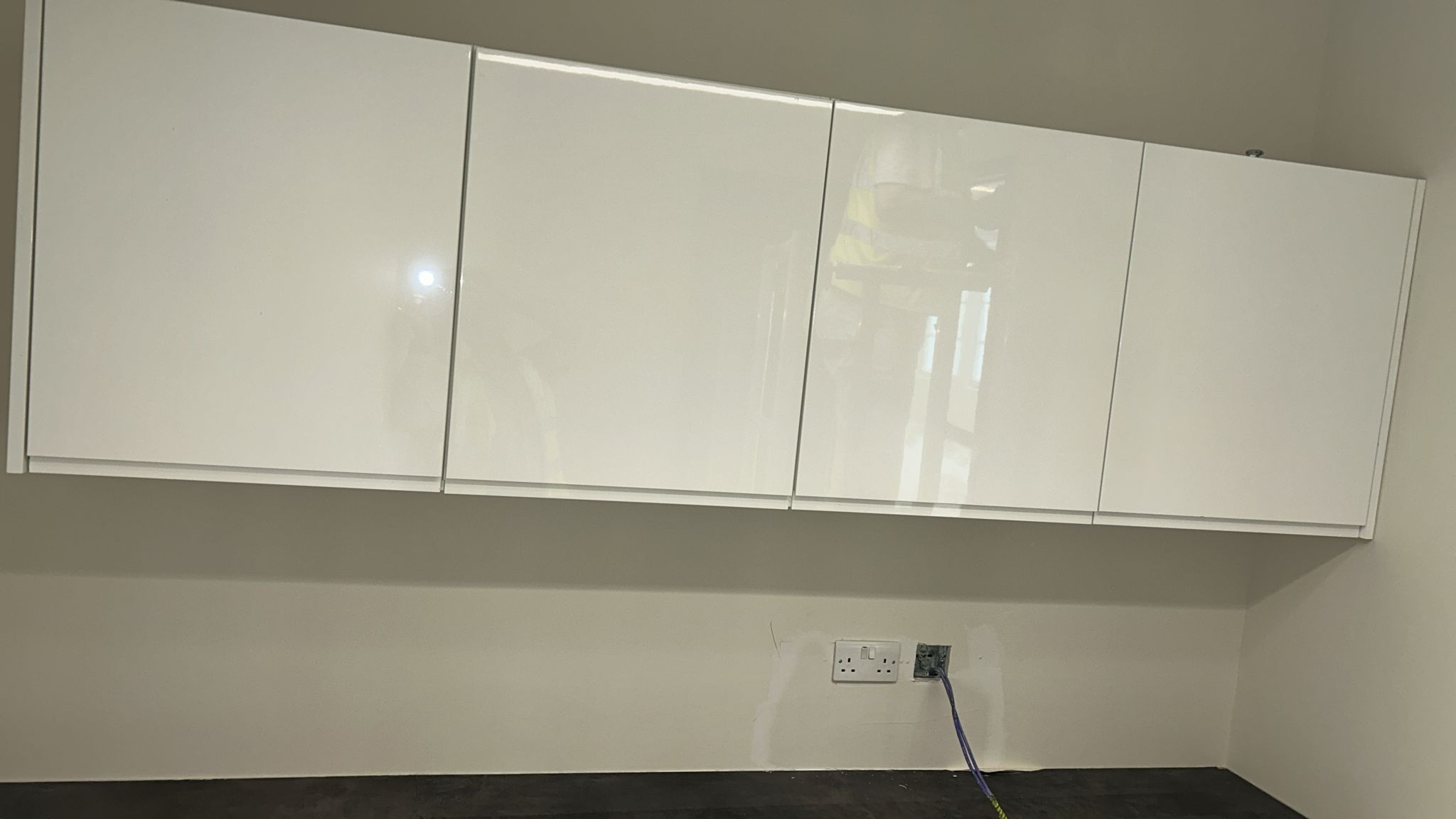 White high-gloss wall units installed with new sockets